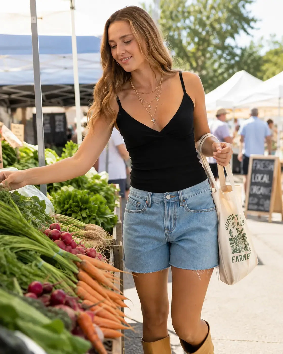 Woman in a black surplice cami shopping produce at a farmers market