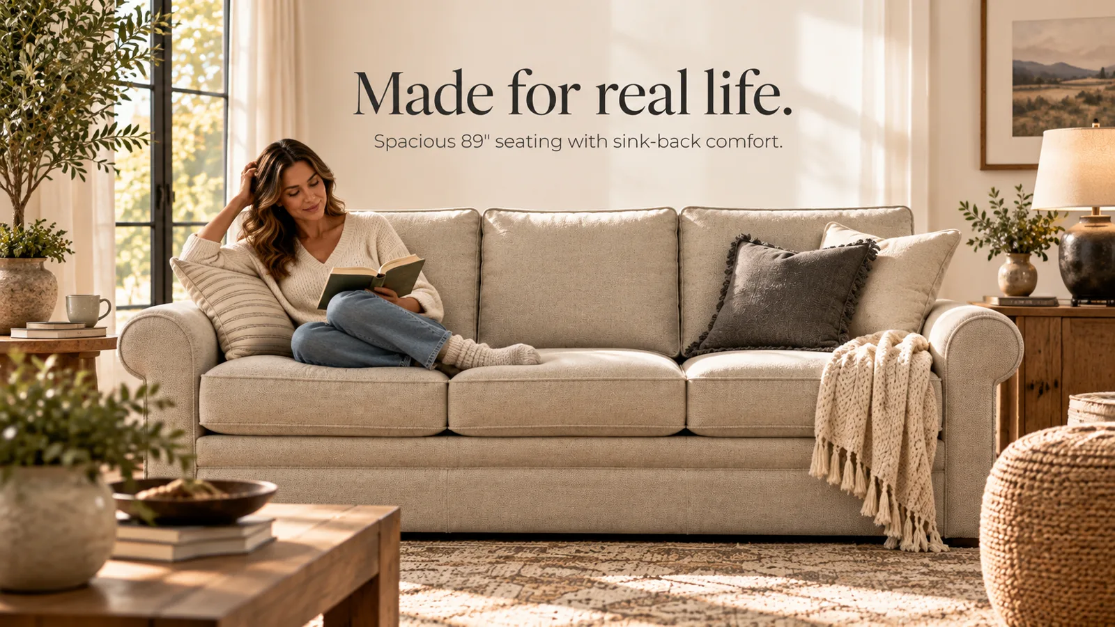 Campaign banner: woman reading on the Collins sofa — "Made for real life. Spacious 89in seating with sink-back comfort."