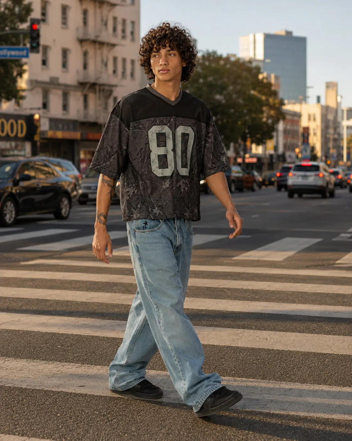 Man in a mesh jersey crossing a city crosswalk